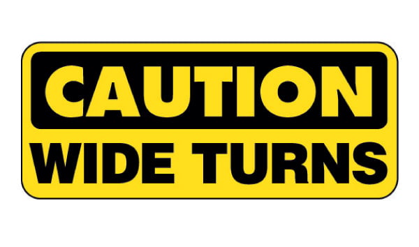 Safety Decal: Caution Wide Turns with Truck Image