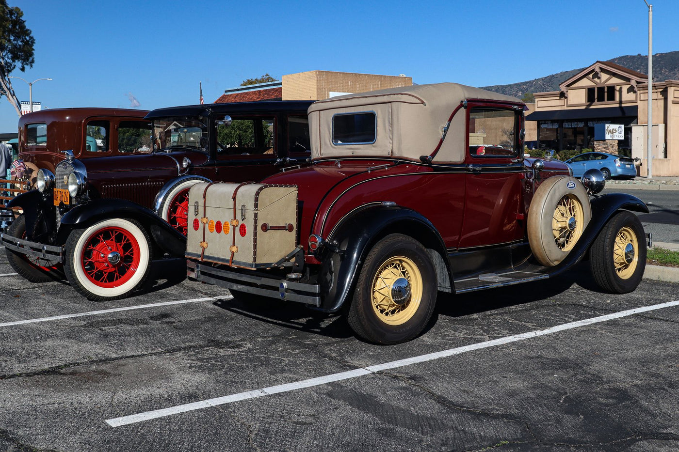 Beautiful vintage cars parked in an outdoor lot, showcasing classic automotive design.